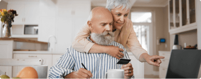 a couple looking at a laptop